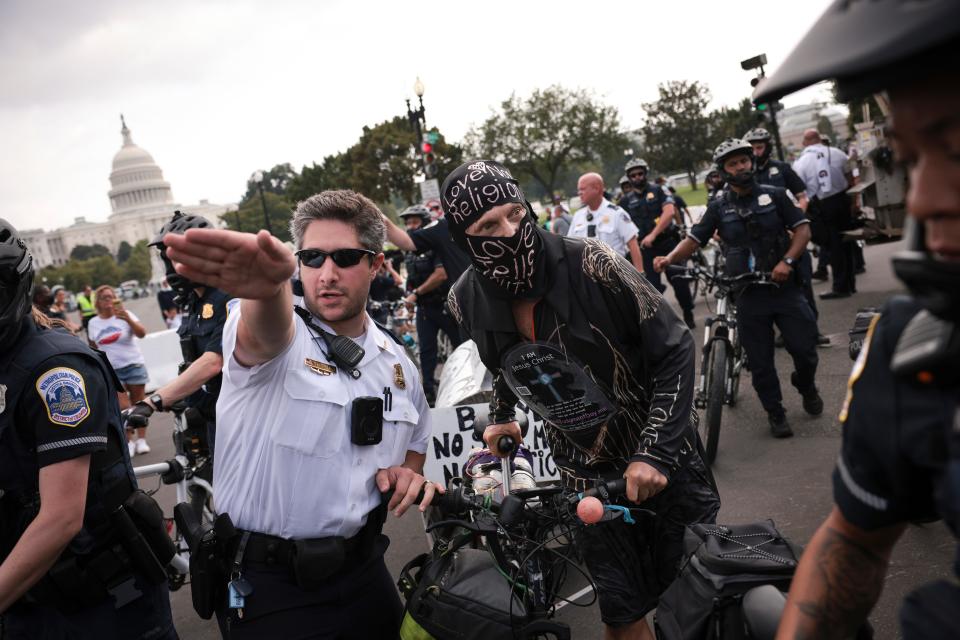 A counter-protestor is escorted out of the rally site by police officers as supporters of those charged in the January 6 attack on the U.S. Capitol attend the 'Justice for J6' rally near the U.S. Capitol September 18, 2021 in Washington, DC.