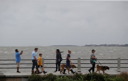 People walk along the waterfront ahead of the arrival of Hurricane Dorian in Charleston