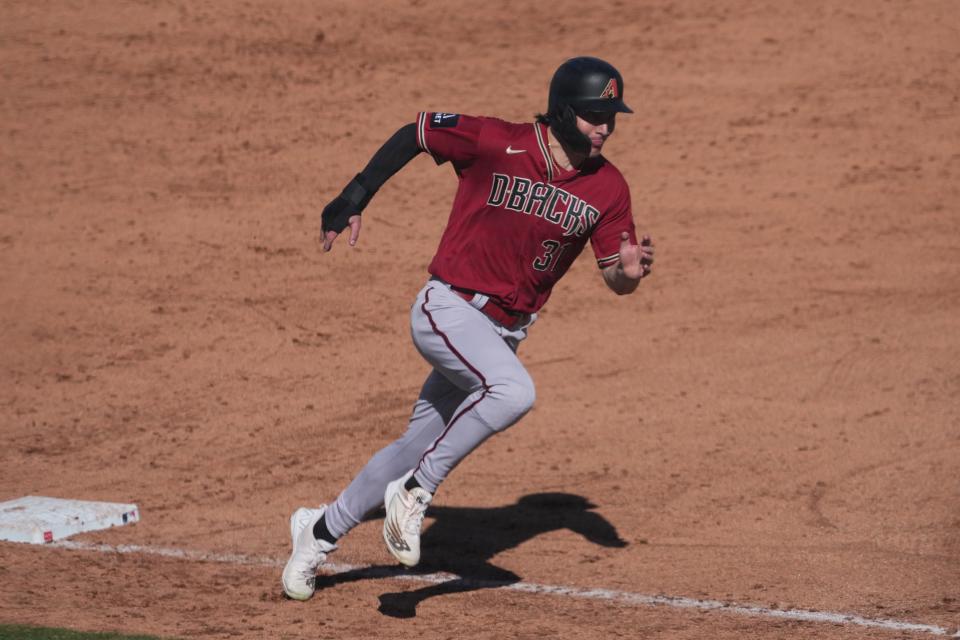 Arizona Diamondbacks right fielder Jake McCarthy (31) rounds third base and scores a run against the San Diego Padres during the sixth inning at Peoria Sports Complex, Feb. 26, 2023.
