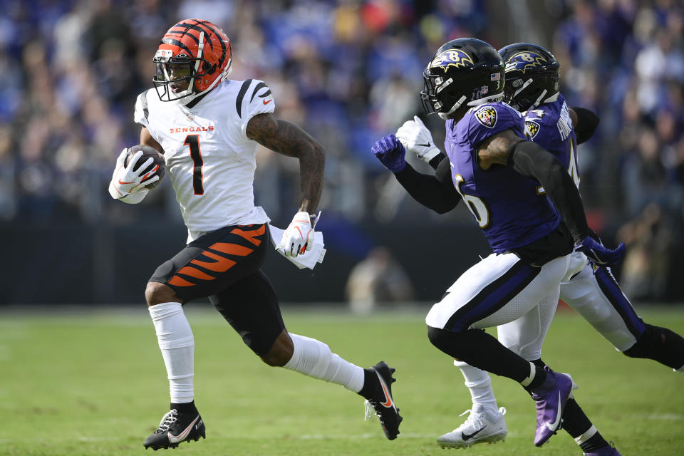 Cincinnati Bengals wide receiver Ja'Marr Chase (1) runs with the ball against Baltimore Ravens safety Chuck Clark (36) and cornerback Marlon Humphrey during the first half of an NFL football game, Sunday, Oct. 24, 2021, in Baltimore. (AP Photo/Nick Wass)