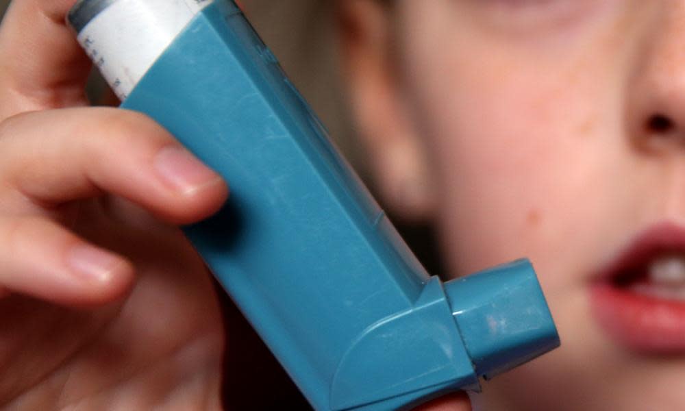 A girl holds an inhaler for the treatment of asthma.