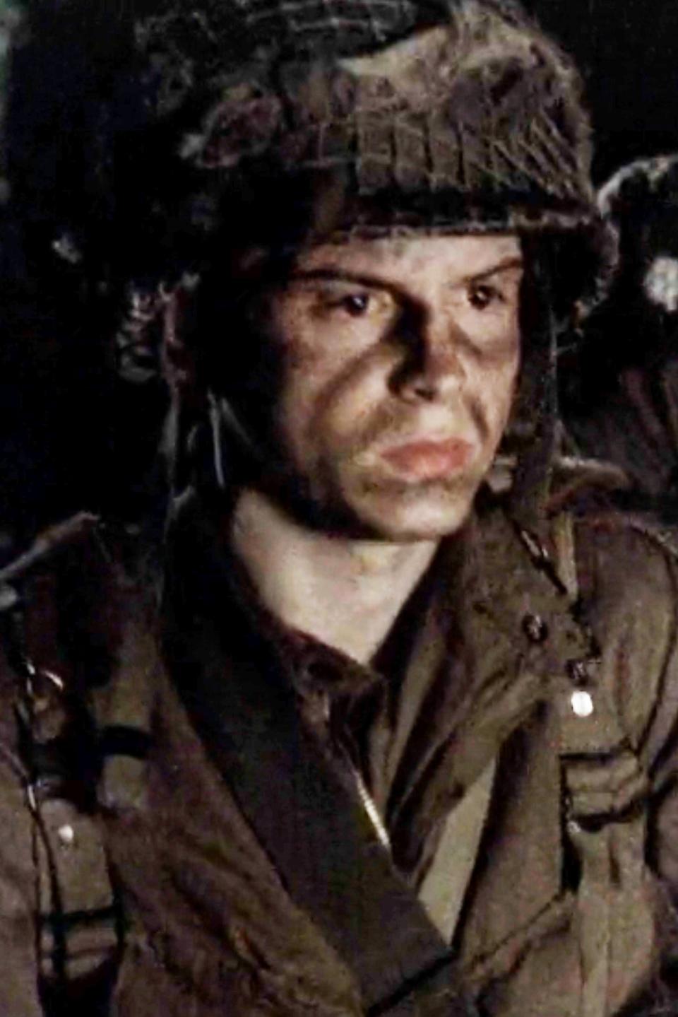 Andrew Scott in military gear and helmet with a serious expression, in a scene from 