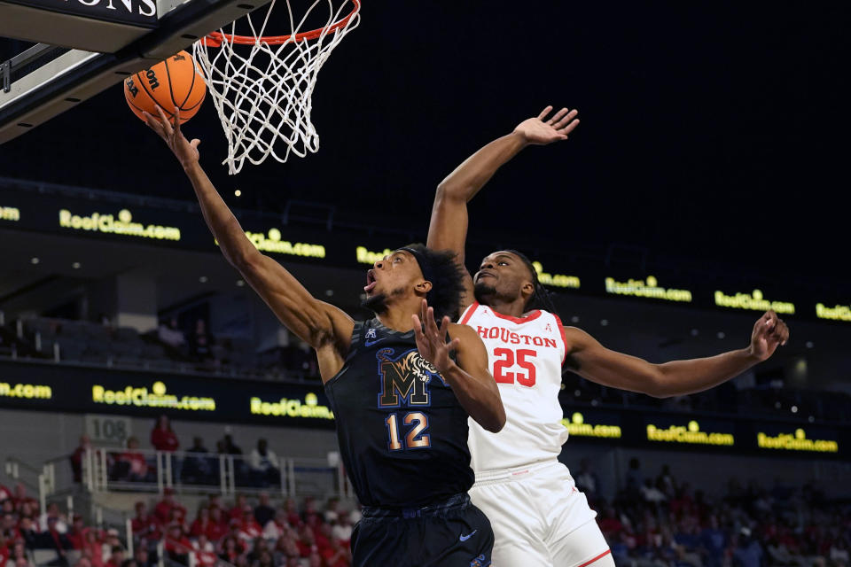 Memphis forward DeAndre Williams (12) scores against Houston forward Jarace Walker (25) during the first half in the finals of the American Athletic Conference Tournament, Sunday, March 12, 2023, in Fort Worth, Texas. (AP Photo/LM Otero)