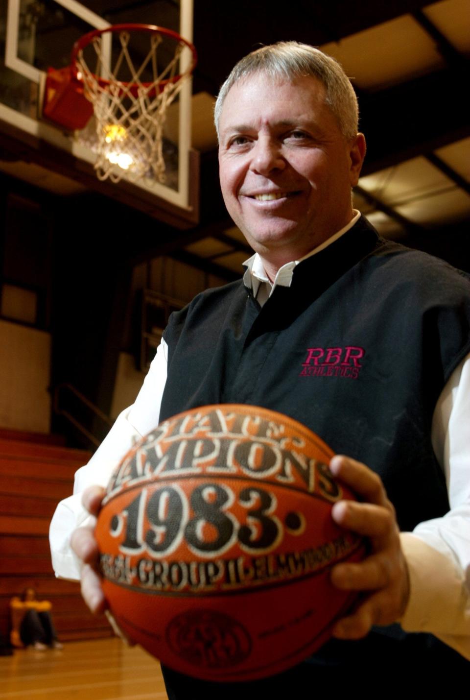 Former Red Bank coach Nick Pizzulli, shown in a 2003 photo, displays a ball from Red Bank's unbeaten 1983 NJSIAA Group 2 championship team.