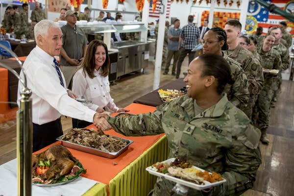 Vice President Mike Pence and his wife Karen Pence, second from left, serve turkey to troops at Al Asad Air Base, Iraq, Saturday, Nov. 23, 2019. The visit is Pence’s first to Iraq and comes nearly one year since President Donald Trump’s surprise visit to the country. (AP Photo/Andrew Harnik)