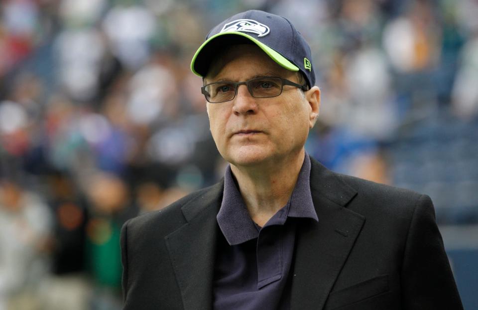 Paul Allen, Microsoft's cofounder, wearing Seattle Seahawks hat while standing in stadium