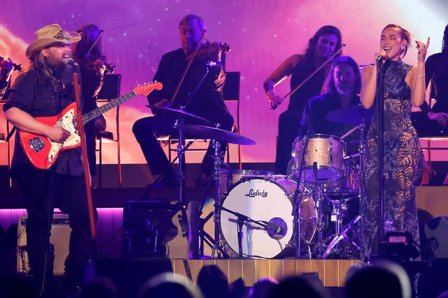 <p>Jason Kempin/Getty</p> Chris Stapleton and Dua Lipa perform onstage during the 59th Academy of Country Music Awards