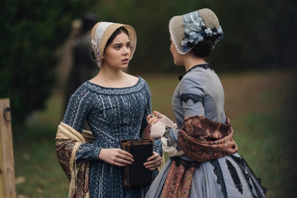 Hailee Steinfeld and Ella Hunt talk in a field wearing bonnets and dresses