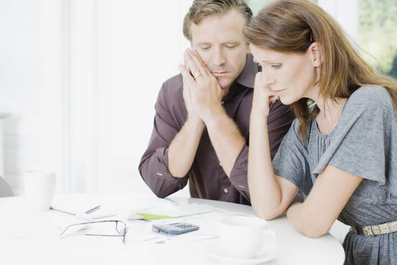 Couple looking over finances, worried