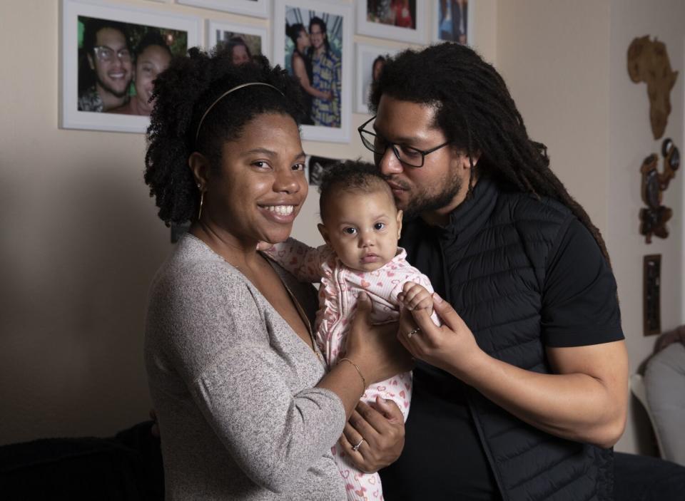 Menelik Tafari shown photographed with his wife, London King, and child Kahli Aminah King Tafari at their Gardena apartment.