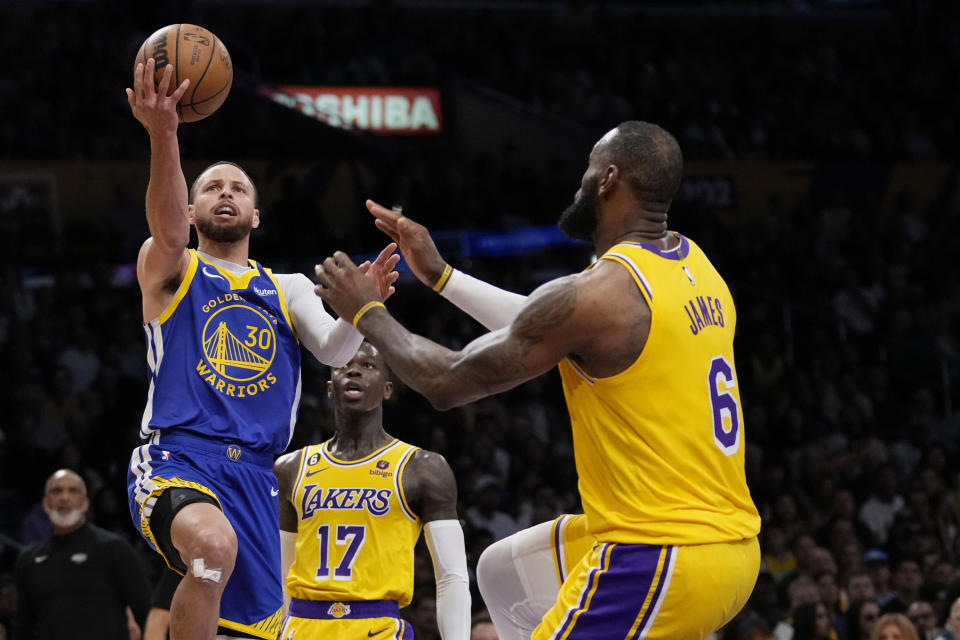 Golden State Warriors guard Stephen Curry (30) shoots over Los Angeles Lakers forward LeBron James (6) during the first half in Game 6 of an NBA basketball Western Conference semifinal series Friday, May 12, 2023, in Los Angeles. (AP Photo/Ashley Landis)