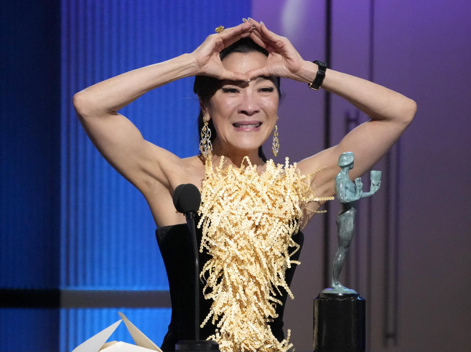 Michelle Yeoh makes a gesture as she accepts the award for outstanding performance by a female actor in a leading role for "Everything Everywhere All at Once" at the 29th annual Screen Actors Guild Awards on Sunday, Feb. 26, 2023, at the Fairmont Century Plaza in Los Angeles. (AP Photo/Chris Pizzello)