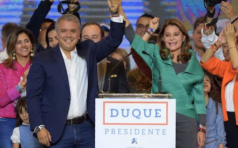 Colombian presidential candidate Ivan Duque, for the Democratic Centre party, and his running mate Marta Lucia Ramirez celebrate with supporters in Bogota - Credit: AFP