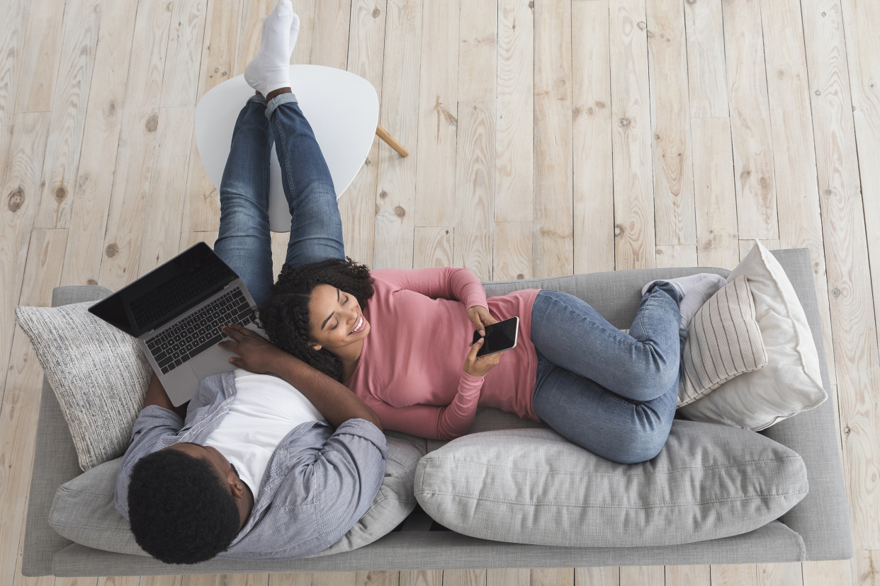 couple at home on laptop and phone