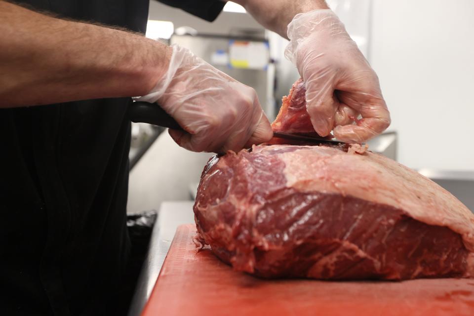 Executive Chef Tom Hughes trims a top sirlion from Creekstone Farms for a smash burger at his new restaurant Tenero Cafe + Butcher in East Memphis on Friday, April 22, 2022. 