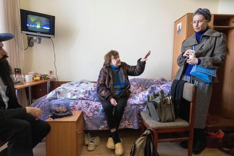 Tatiana Larina, 73, of Mykolaiv, Ukraine, tells Olena Khorenjenko, right, about her journey to a refugee housing center at Bukoria Pension in the Vodola-Veda Holiday suburb near Chisinau, Moldova, on March 24.