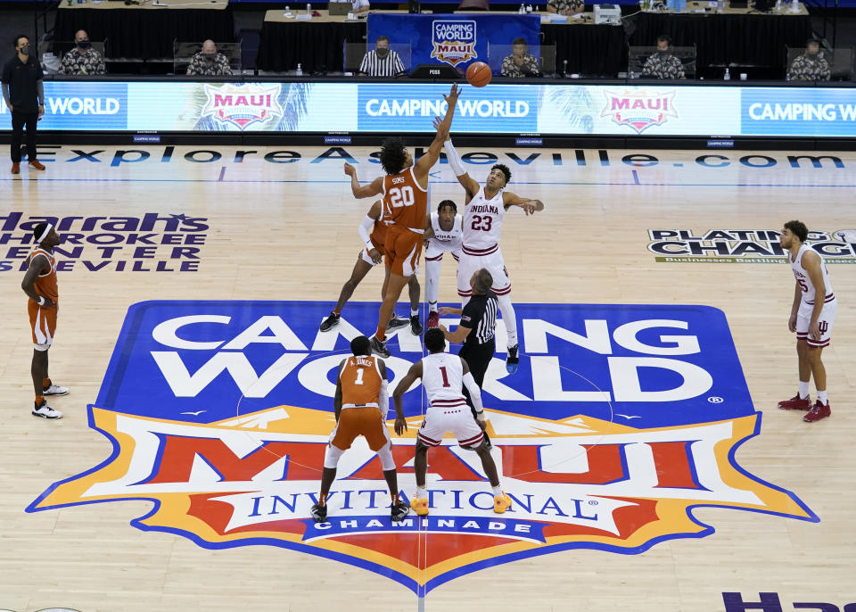 Texas forward Jericho Sims (20) and Indiana forward Trayce Jackson-Davis (23) tip off for the start of a semifinal NCAA college basketball game in the Maui Invitational tournament, Tuesday, Dec. 1, 2020, in Asheville, N.C. (AP Photo/Kathy Kmonicek)