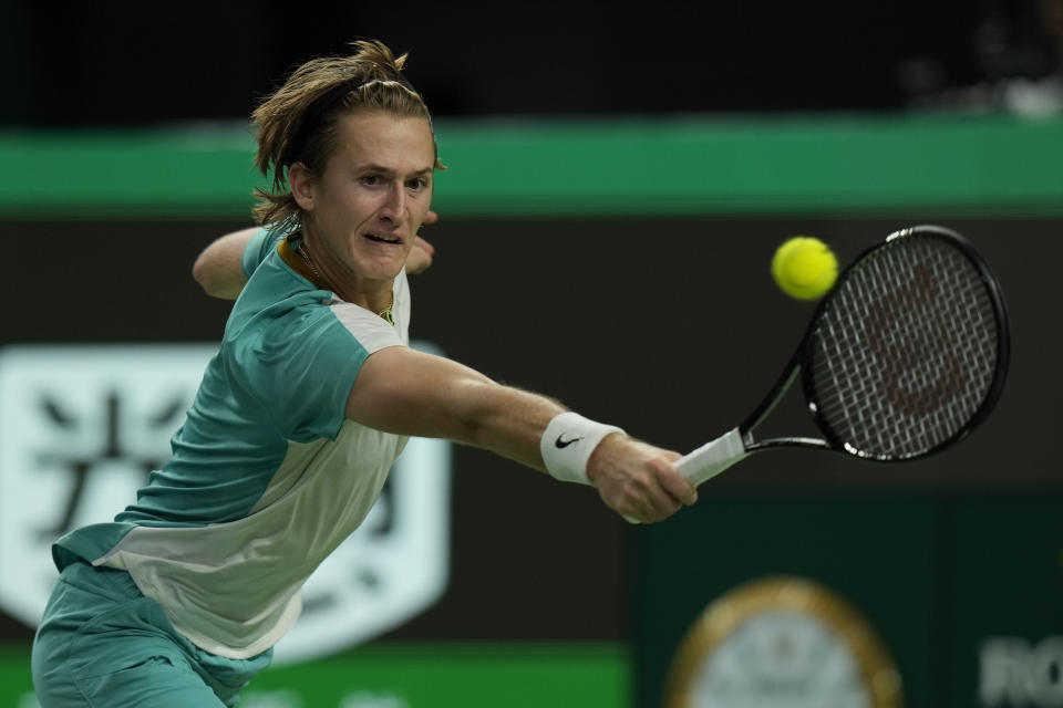 Sebastian Korda of the United States returns a shot to his compatriot Ben Shelton during the men's singles quarterfinal match of the Shanghai Masters tennis tournament at Qizhong Forest Sports City Tennis Center in Shanghai, China, Thursday, Oct. 12, 2023. (AP Photo/Andy Wong)