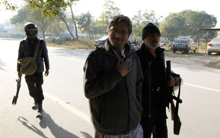 A demostrator detained by police gestures as he is led to a police van near the Faizabad junction in Islamabad, Pakistan November 25, 2017. REUTERS/Caren Firouz