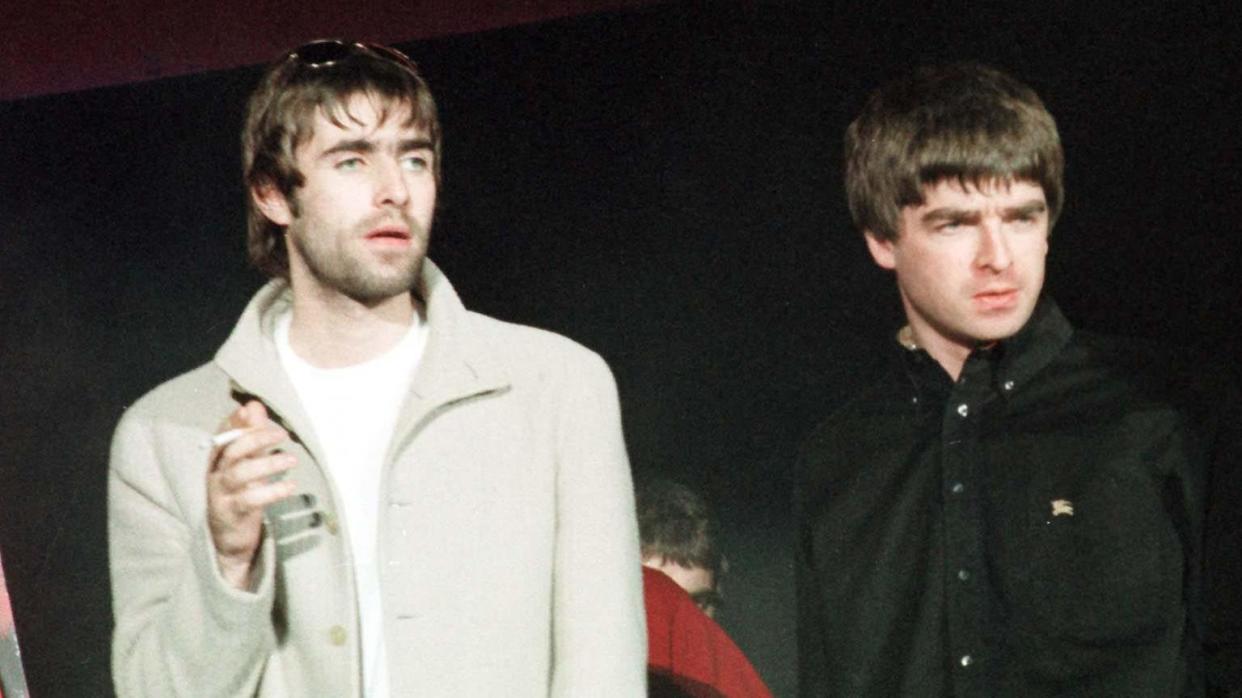 Oasis lead singer Liam Gallagher (left) and his brother Noel at the Cardiff International Arena in 1997