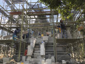 In this July 29, 2019, photo, workers renovate a temple at Prambanan Temple Complex in Yogyakarta, Indonesia. The Indonesian city of Yogyakarta and its hinterland are packed with tourist attractions, including Buddhist and Hindu temples of World Heritage. Yet many tourists still bypass the congested city and head to the relaxing beaches of Bali. Recently re-elected President Joko Widodo wants to change this dynamic by pushing ahead with creating "10 new Balis," an ambitious plan to boost tourism and diversify South Asia's largest economy. (AP Photo/Karin Laub)