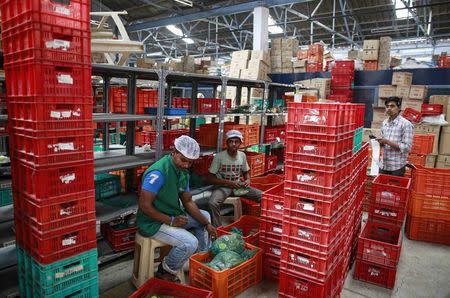 Employees sort out orders before sending them out at a Big Basket warehouse on the outskirts of Mumbai November 4, 2014. REUTERS/Danish Siddiqui