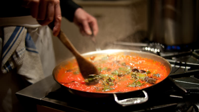 stirring tomato sauce