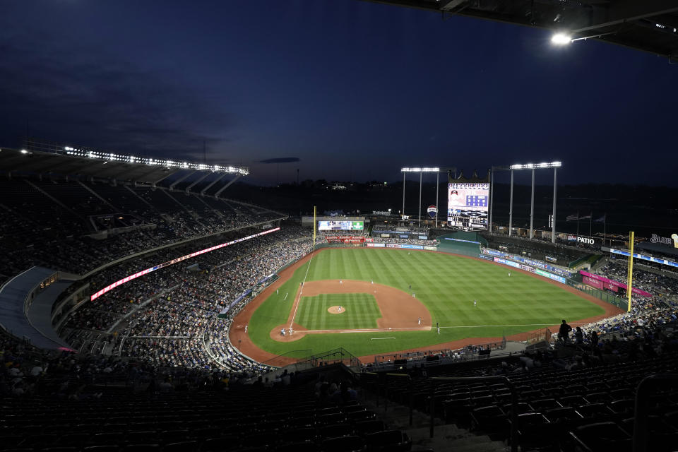 Fans watch during the fifth inning of a baseball game between the Kansas City Royals and the Atlanta Braves Friday, April 14, 2023, in Kansas City, Mo. The Braves won 10-3. (AP Photo/Charlie Riedel)