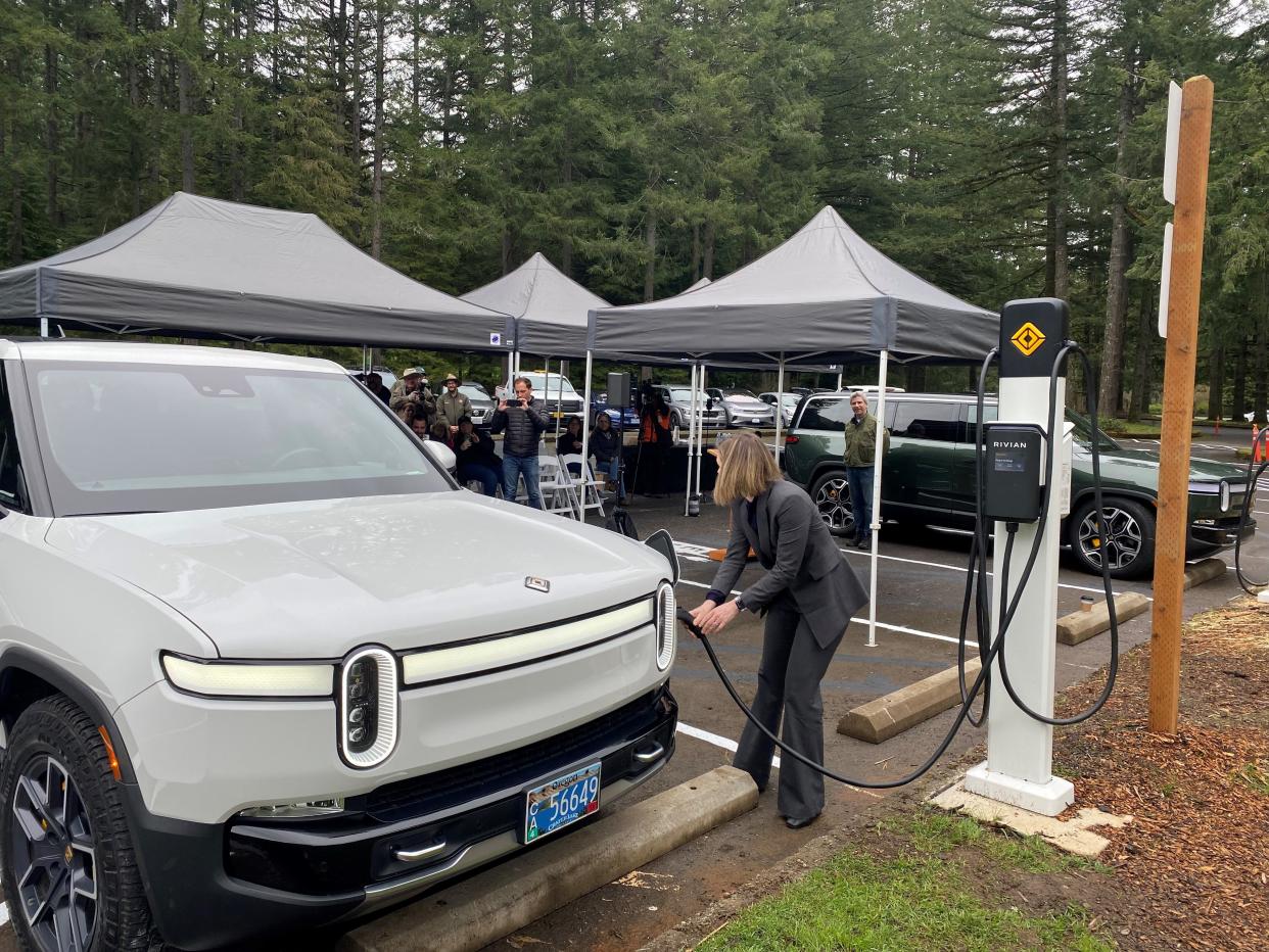 Kelly Brooks of the governor's office using one of two new electric vehicle chargers at Silver Falls State Park.