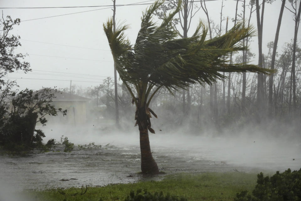 CORRECTS FROM CANAL TO ROAD - A road is flooded during the passing of Hurricane Dorian in Freeport, Grand Bahama, Bahamas, Monday, Sept. 2, 2019. Hurricane Dorian hovered over the Bahamas on Monday, pummeling the islands with a fearsome Category 4 assault that forced even rescue crews to take shelter until the onslaught passes. (AP Photo/Tim Aylen)