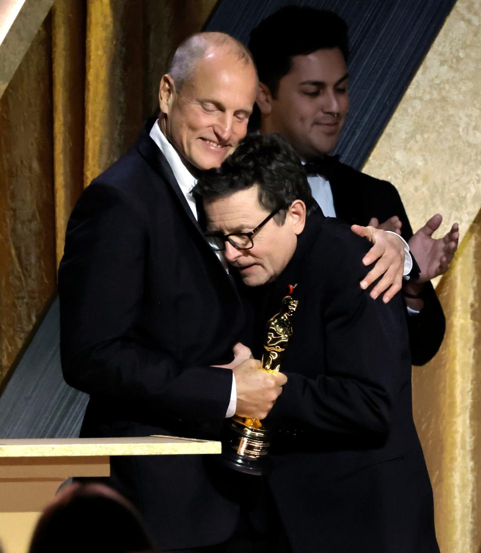 Woody Harrelson (left) congratulates Michael J. Fox, winner of the Jean Hersholt Humanitarian Award, during the Academy of Motion Picture Arts and Sciences' 13th Governors Awards.