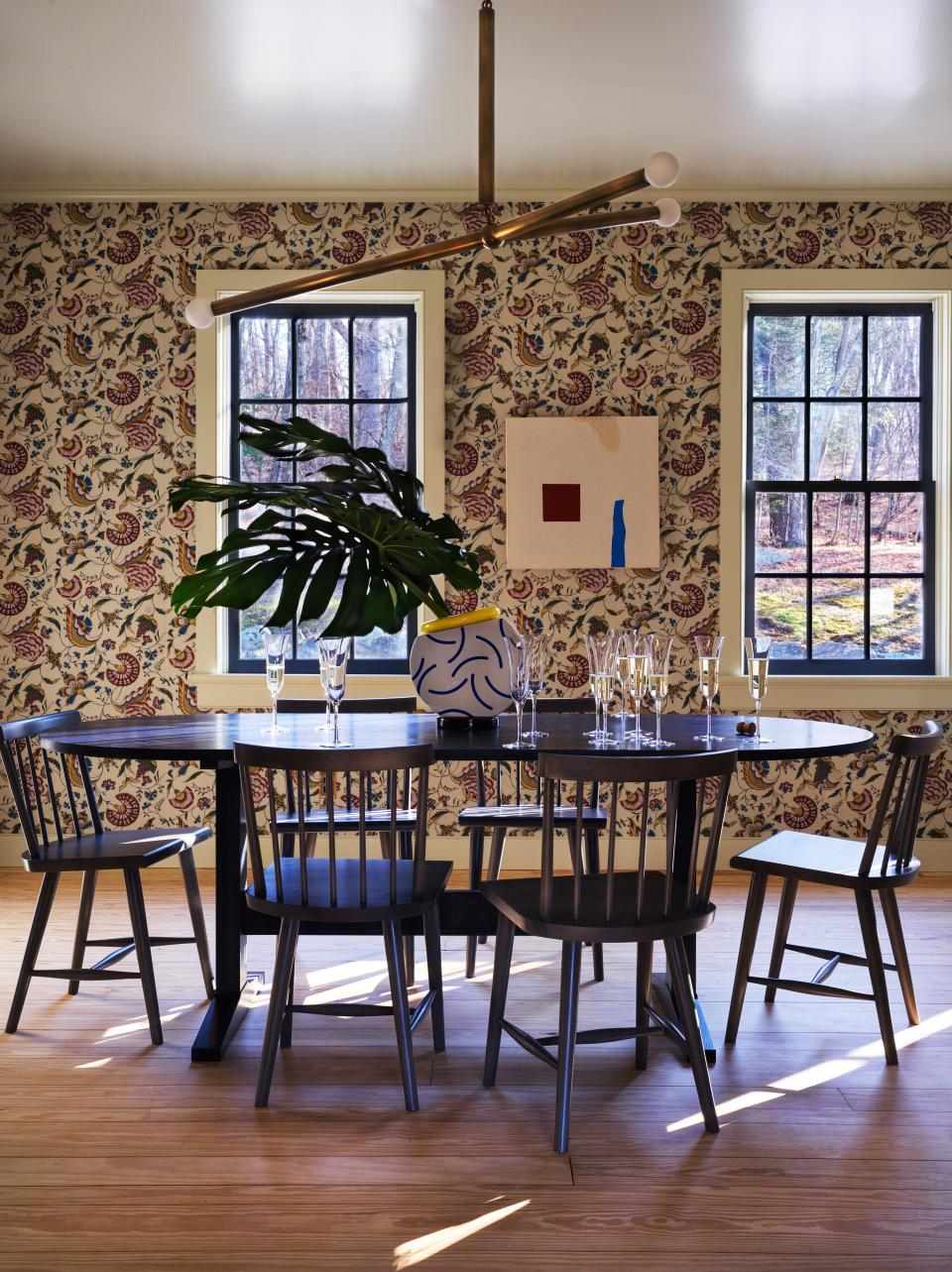 In the dining room, Antoinette Poisson wallpaper, Apparatus ceiling light, and table and chairs by O&G studio.