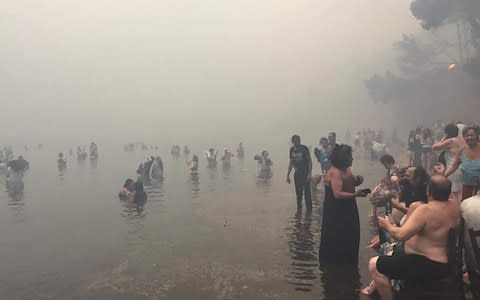 Dozens of people flee to the beach in Mati - Credit: Blitz Pictures