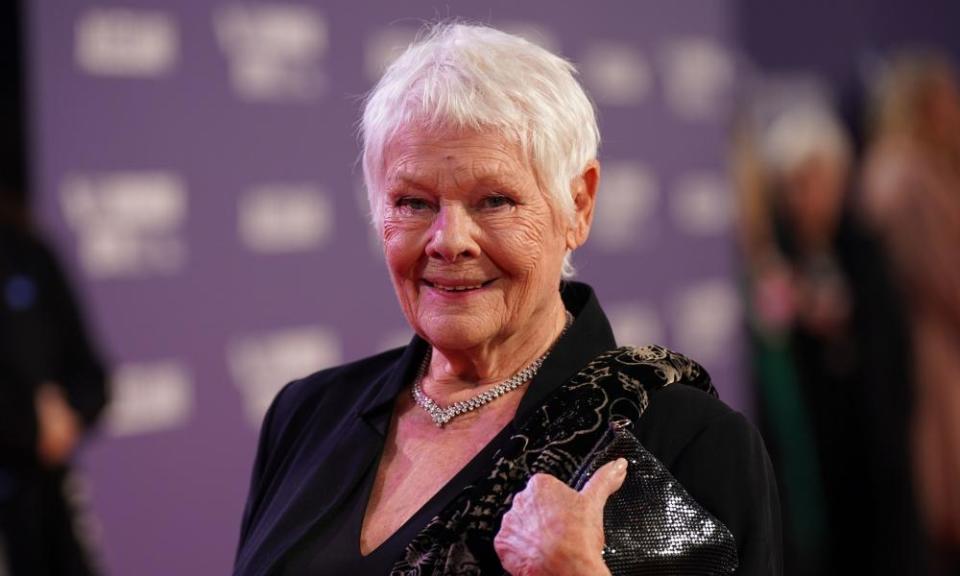 Judi Dench, pictured at a press event and wearing a black jacket and glittering necklace