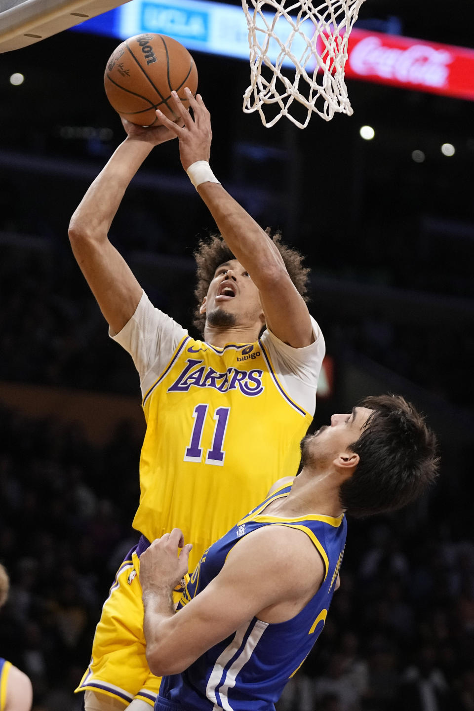 Los Angeles Lakers center Jaxson Hayes, top, shoots as Golden State Warriors forward Dario Saric defends during the first half of an NBA preseason basketball game Friday, Oct. 13, 2023, in Los Angeles. (AP Photo/Mark J. Terrill)