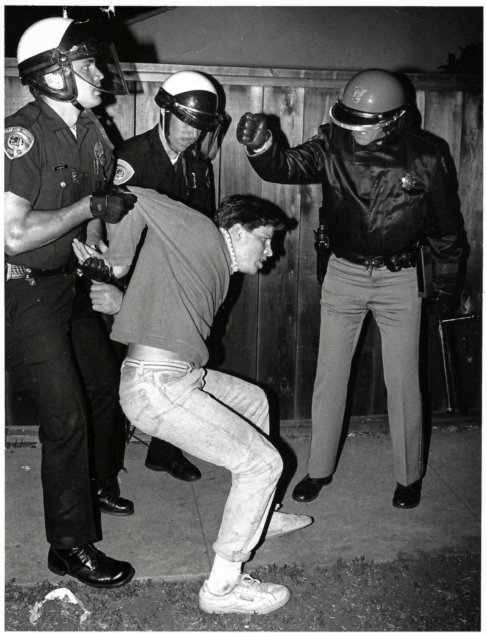 Officers make an arrest Friday night April 27, 1990.