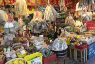 A Thai vendor wears a face mask to protect from the new coronavirus at a grocery store in Bangkok, Thailand, Thursday, April 23, 2020. A month-long state of emergency remain enforced in Thailand to allow its government to impose stricter measures to control the coronavirus that has infected hundreds of people in the Southeast Asian country. (AP Photo/Sakchai Lalit)