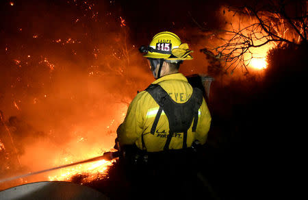 Firefighters battle the Thomas wildfire in the hills and canyons outside Montecito, California, U.S., December 16, 2017. REUTERS/Gene Blevins