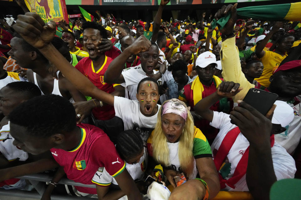 Guinean fans celebrate their team's victory after the African Cup of Nations Round of 16 soccer match between Equatorial Guinea and Guinea, at the Olympic Stadium of Ebimpe in Abidjan, Ivory Coast, Sunday, Jan. 28, 2024. (AP Photo/Themba Hadebe)