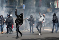 <p>Hooded youths throw bottles during clashes at a demonstration to protest the results of the first round of the presidential election in Paris, France, April 27, 2017. (Gonzalo Fuentes/Reuters) </p>