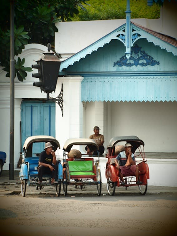 Looking for business: Pedicab drivers wait for tourists in front of the Kraton complex. (