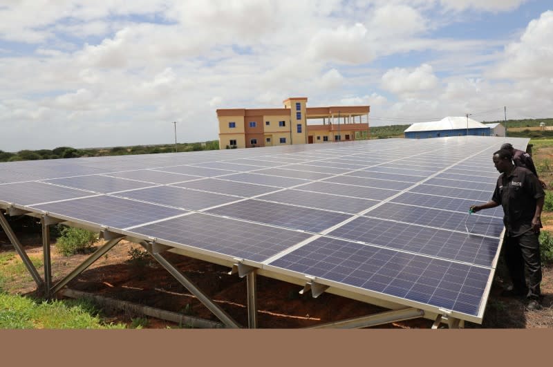 Engineers work on solar panels at the Benadir Electricity Company (BECO) solar project in Mogadishu