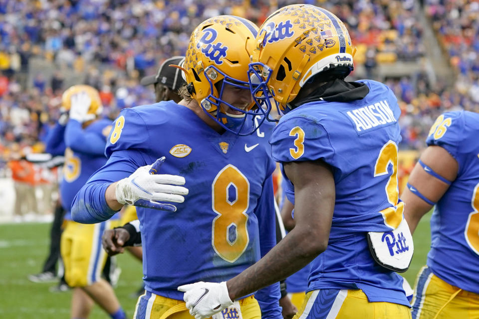 Pittsburgh quarterback Kenny Pickett (8) celebrates with wide receiver Jordan Addison (3) after throwing him a touchdown pass against Clemson during the first half of an NCAA college football game, Saturday, Oct. 23, 2021, in Pittsburgh. (AP Photo/Keith Srakocic)