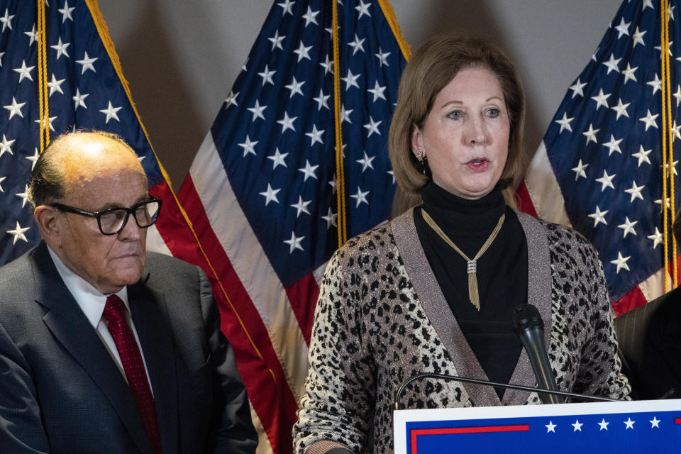 FILE - In this Nov. 19, 2020 file photo, Sidney Powell, right, speaks next to former Mayor of New York Rudy Giuliani, as members of President Donald Trump's legal team, during a news conference at the Republican National Committee headquarters in Washington. On Friday, June 4, 2021, The Associated Press reported on stories circulating online incorrectly asserting election technology firm Dominion Voting Systems lost its lawsuits against Powell and Giuliani. Dominion’s defamation lawsuits against the pair are ongoing, according to legal records. (AP Photo/Jacquelyn Martin, File)