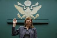General Motors (GM) Chief Executive Mary Barra (C) is sworn in prior to testifying before a House Energy and Commerce Committee hearing on GM's recall of defective ignition switches, on Capitol Hill in Washington April 1, 2014. REUTERS/Kevin Lamarque