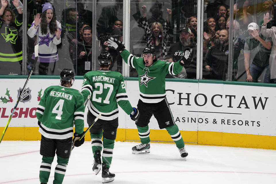 Dallas Stars' Miro Heiskanen (4), Mason Marchment (27) and Matt Duchene, right, celebrate after a goal that was scored by teammate Tyler Seguin in the third period of an NHL hockey game against the New York Rangers in Dallas, Monday, Nov. 20, 2023. (AP Photo/Tony Gutierrez)