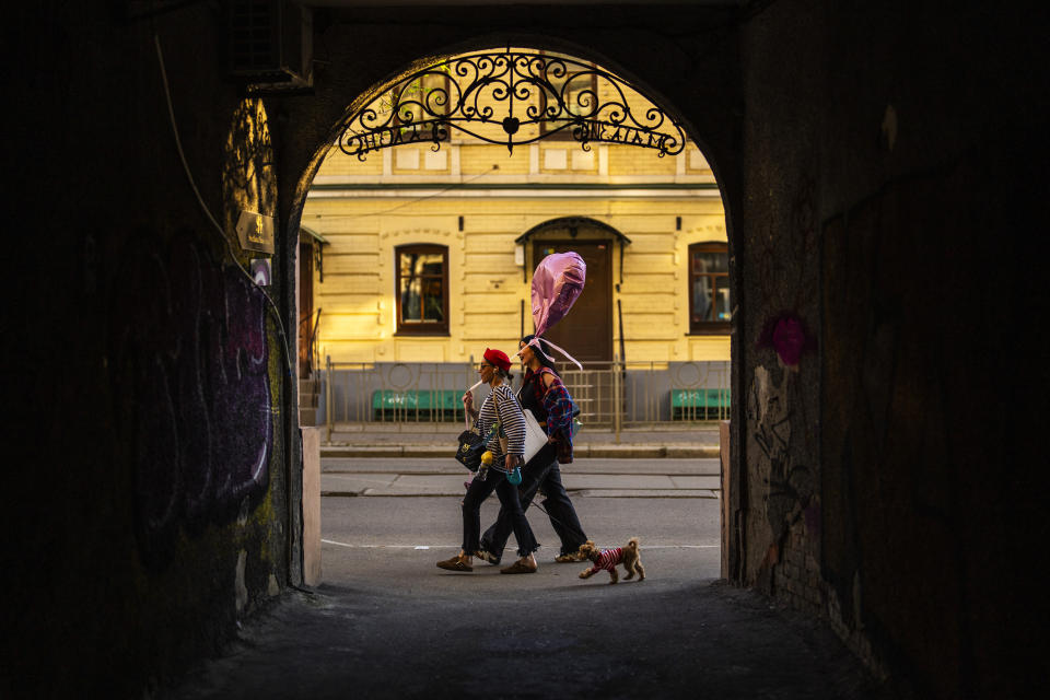 Two women walk along a street in downtown Kyiv, Ukraine, Sunday, April 28, 2024. (AP Photo/Francisco Seco)