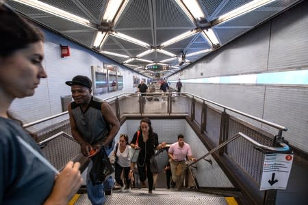 Commuters are seen inside the Fulton Street subway station after police investigated two suspicious packages in Manhattan