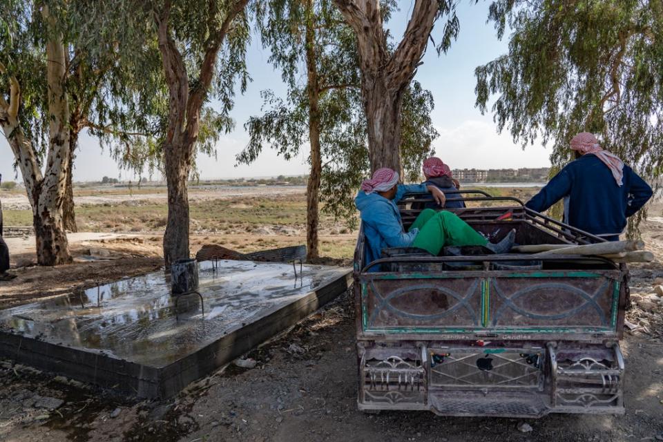 Water truckers in Raqqa look out over the dwindling Euphrates (Bel Trew)