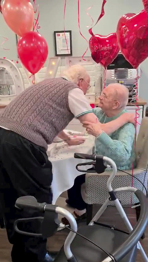 This is the moving moment a devoted wife surprised her dementia-stricken husband by moving into his care home after a month apart - because she 'can't live without him'. Pensioner Kenneth Meredith, 96, walked through the door with his zimmer-frame and broke down in tears when he saw wife Betty Meredith, 91, sitting down in front of him. Seconds later he rushes over to his wife of 71-years, who is seen sitting at a table for a make-shift date night, decorated with heart shaped balloons and roses. With The Platters' 1954 hit 'Only You', playing in the background, the couple share a long hug, after spending five weeks apart. The pair were heartbroken after Kenneth moved into Bourn View Care Home, Birmingham, five weeks ago due to his worsening battle with Alzheimer's. Due to strict rules, he couldn't see wife Betty, who he has been with for 76 years. And with no sign the pandemic was lifting, lonely Betty asked if she could be moved into the care home because she could no longer be apart from her husband. Unbeknown to Kenneth, Betty had moved into the floor below as she waited for her Covid-19 test results - but would continue to phone him for their daily chats. Once her results came back negative, Betty and staff helped arrange the surprise for Kenneth on November 10.